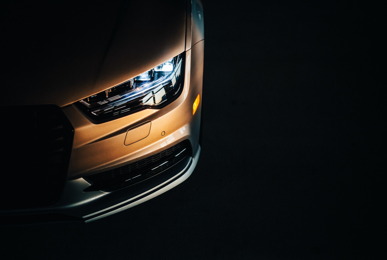 partially lit still life image of a car