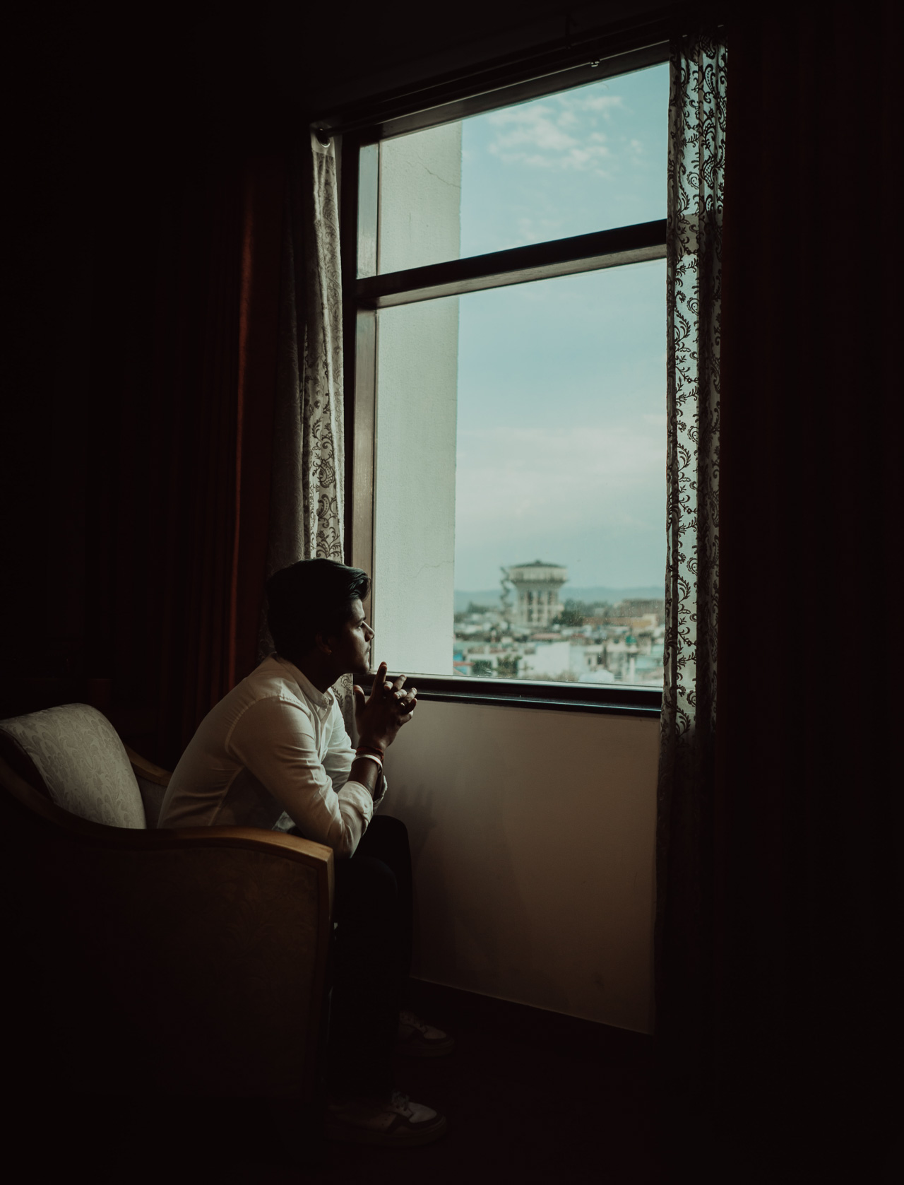 man sitting in a dark room